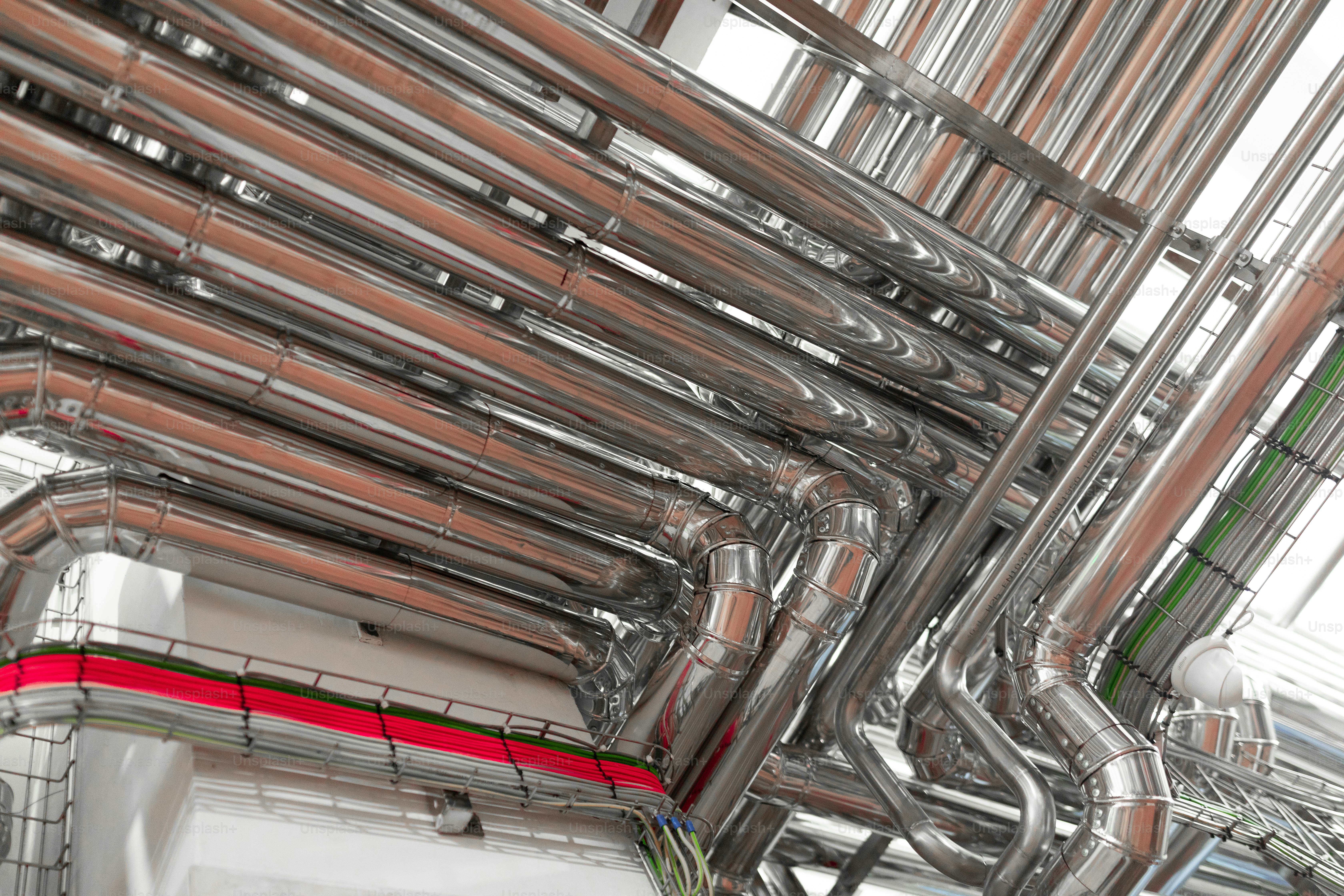 Steel pipelines on raw milk factory. Industrial zone, Steel pipelines and valves. Steam pipeline and steel structure. Equipment, cables and piping as found inside of industrial power plant